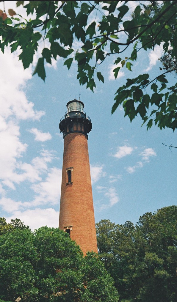 Brick lighthouse against a blue sky