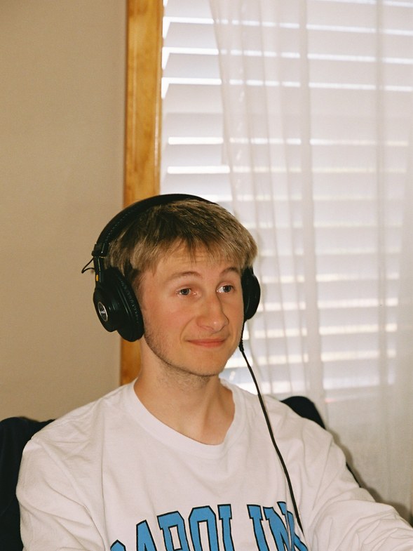Student wearing headphones at a laptop