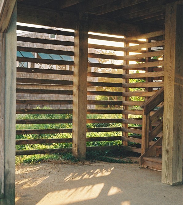 View through wooden slats beneath a beach house