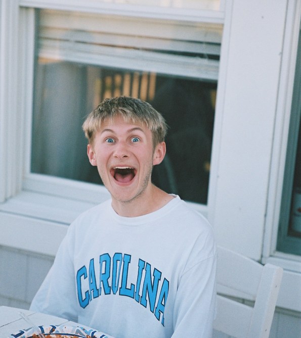 Student laughing in a Carolina sweatshirt