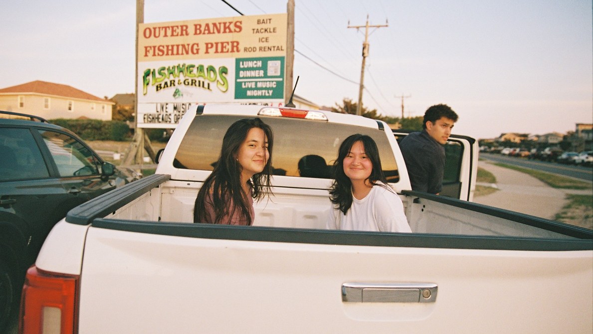 Students sitting in the bed of a pickup truck