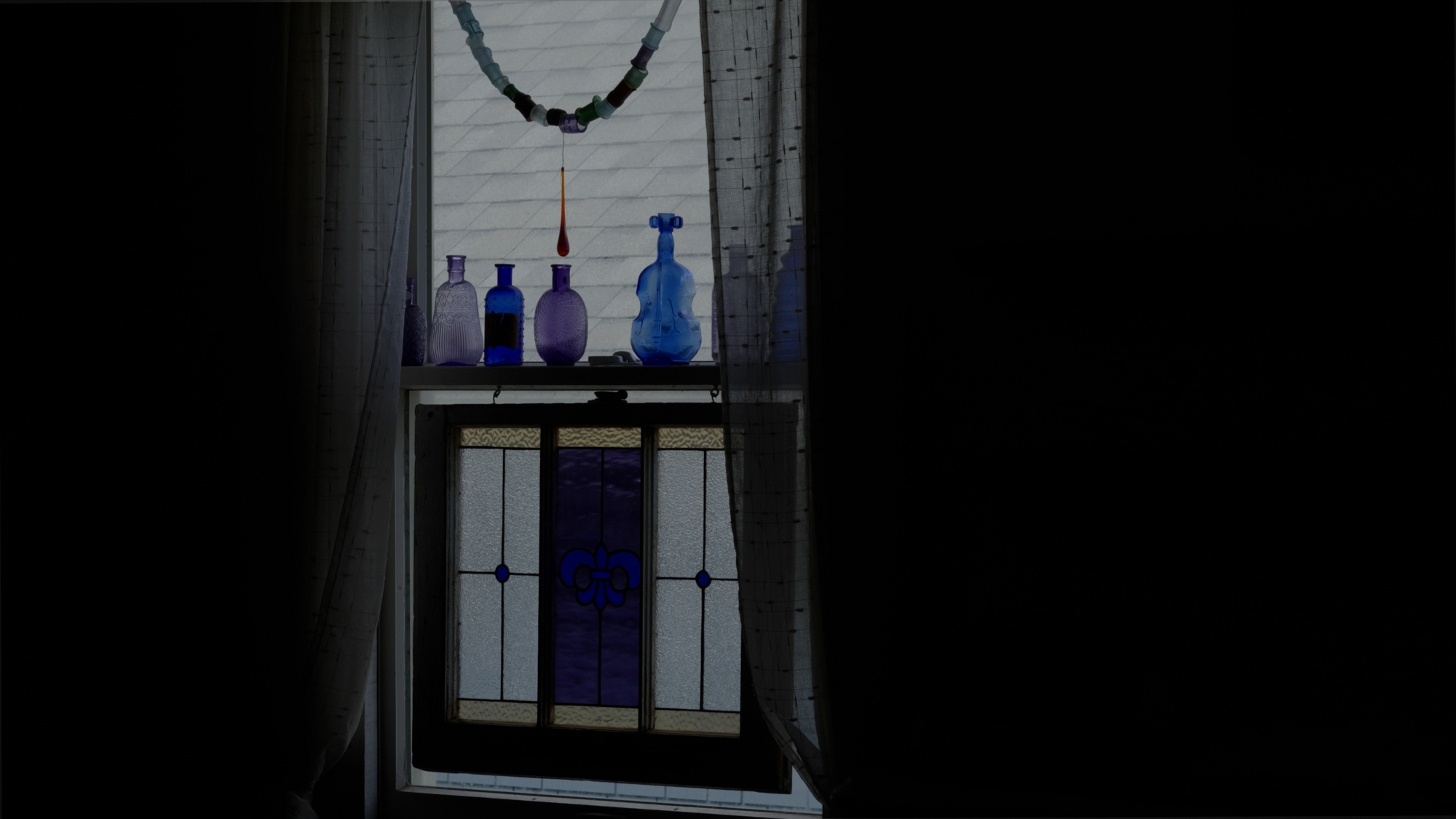 Evans keeps colorful bottles on her windowsill, as her mother once did.