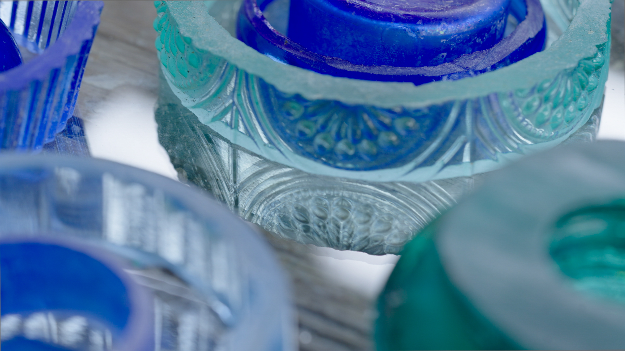 Evansu2019 husband cuts the bottles into slices of varying sizes, which she arranges in windows.