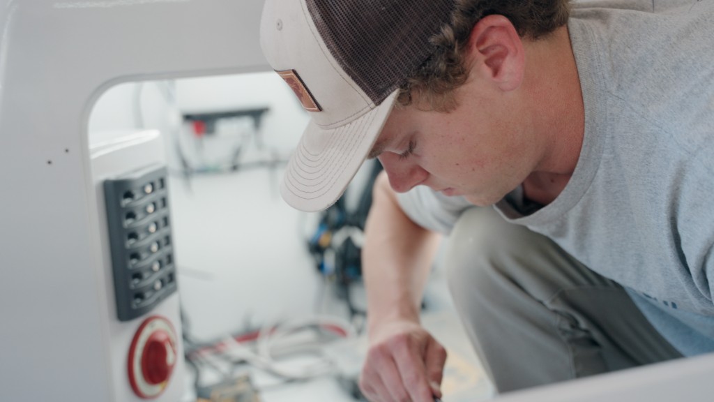 Burch Harrison works on the wiring of the inner console of an ongoing project. Patrick Harrison cherishes working with this son. u201cHeu2019s a total natural,u201d he observes.