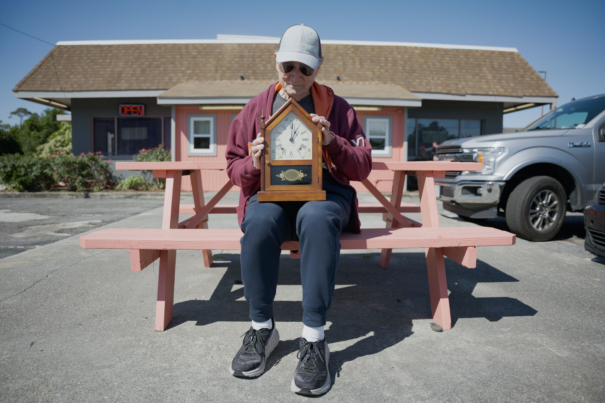 Charlie Snow found himself holding a clients clock that needs repaired. He sits outfront of TL's Family Restaurant in…