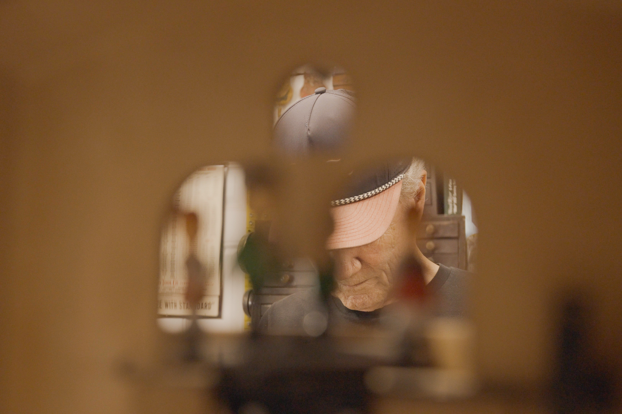 Charlie stands behind a cuckoo clock inside the shop. This was a recent project he helped with for making the dancers…
