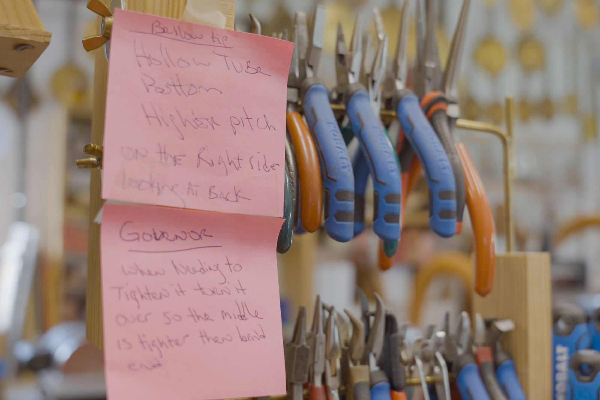 Sticky notes hang from the plyer shelf because the assistant needs to instructions as they learn the craft of clock r…