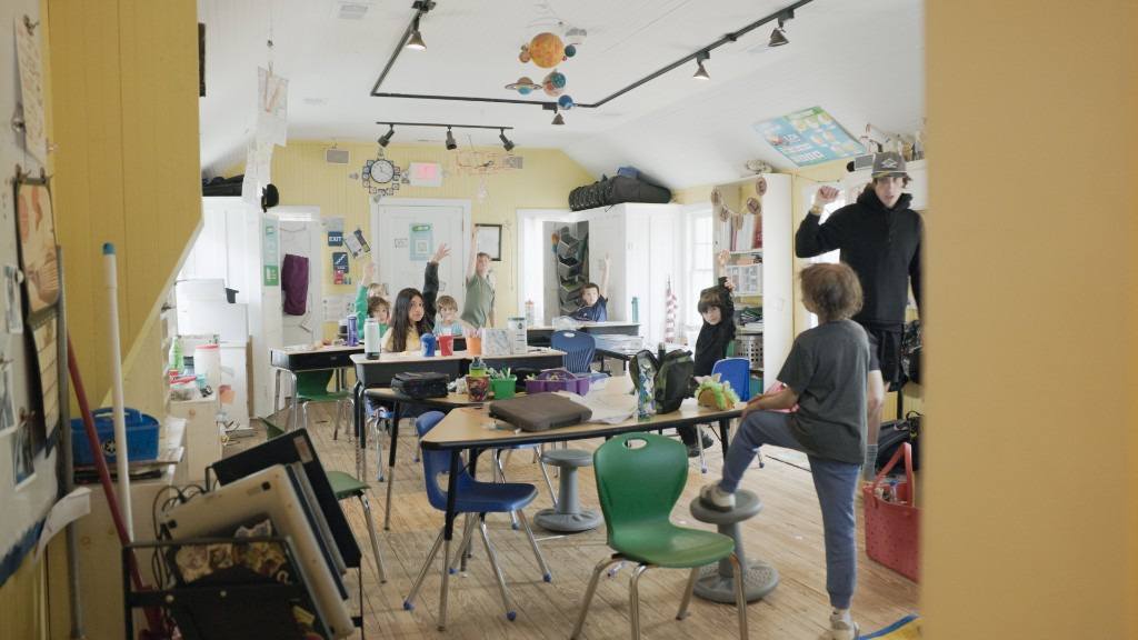 Students of (WEVS) eagerly raise their hands in excitement while they learn in the historic one room schoolhouse.