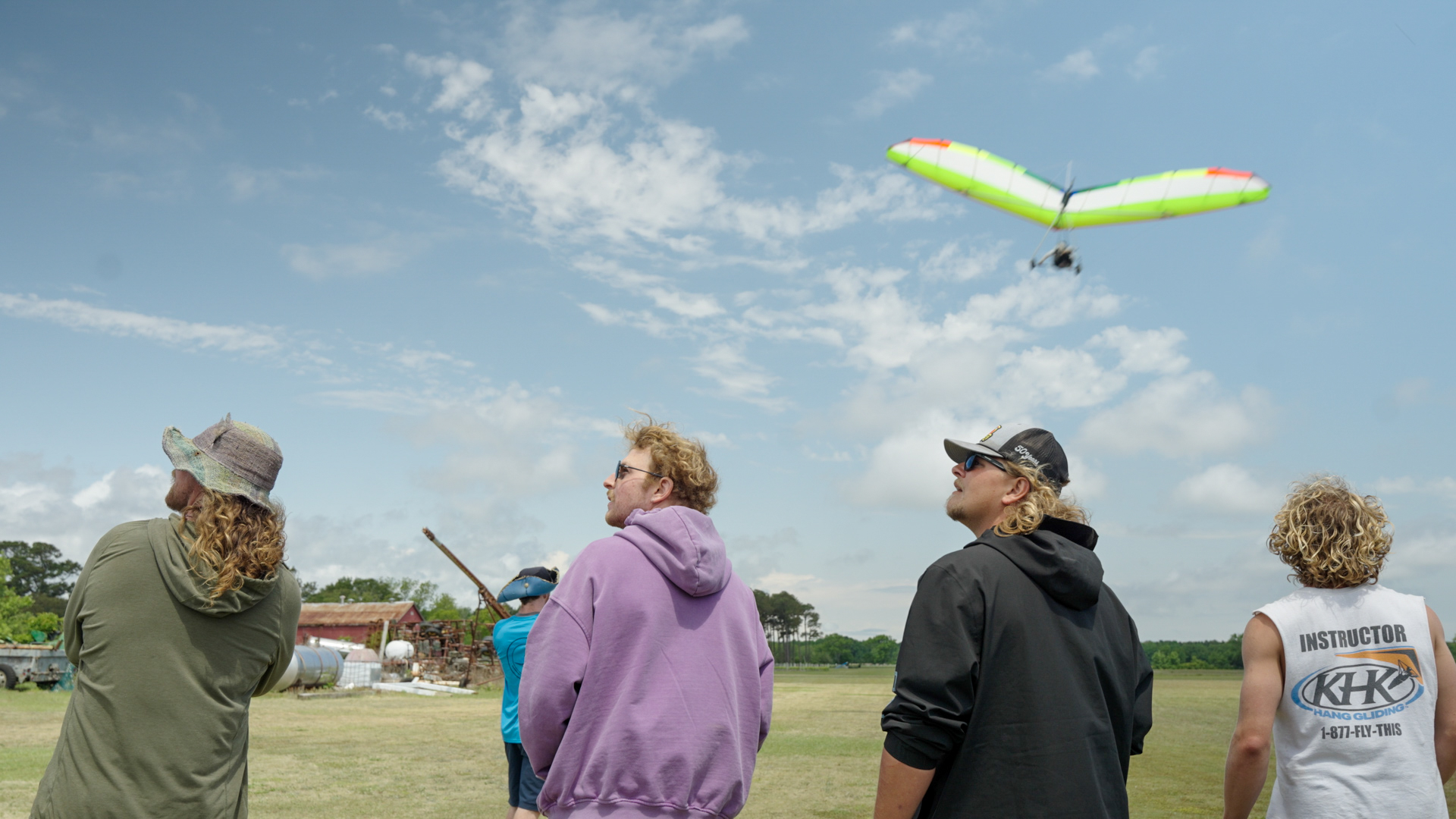 Willie Vaughn and three other instructors gaze on as a pilot comes in for landing at the Cotton Gin in Currituck.