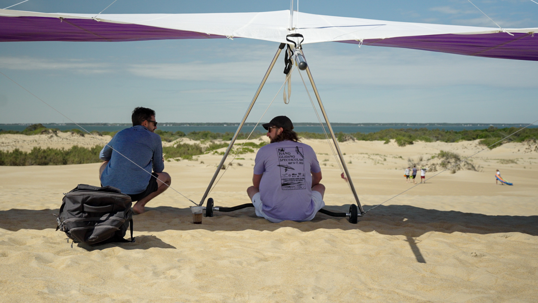 Paul Mazzoni (center) and Ryan Salvo (left) wait for the last day of competition to begin on the dunes at Jockey's Riu2026