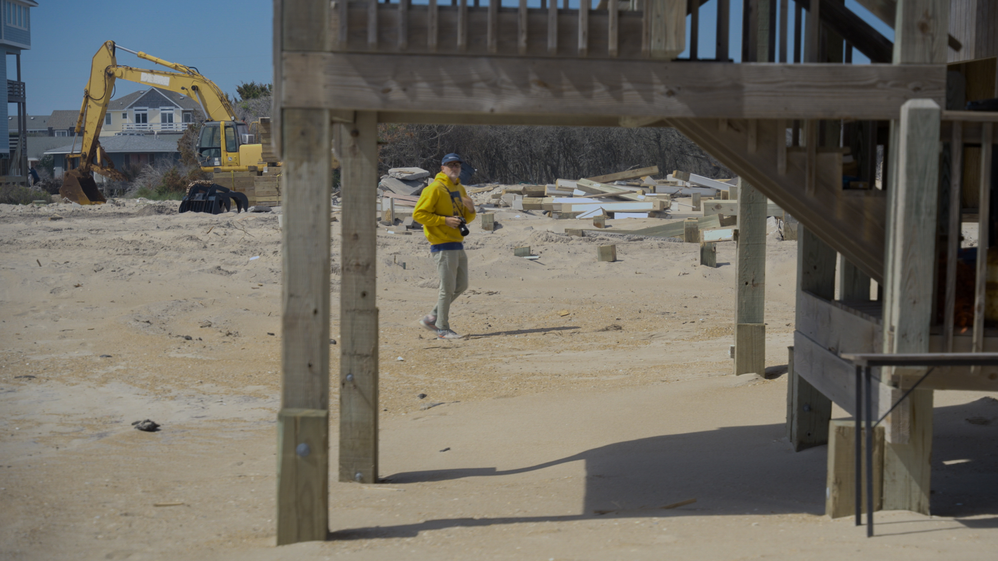 On May 13, 2026 In Buxton, NC, on Old Lighthouse Rd, Pullen walks toward the wood beams left behind by a house that w…
